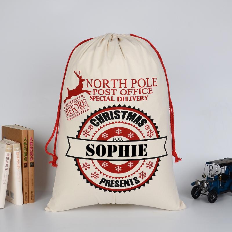 A personalised Christmas postage themed cotton sack with a child's name added to the design.