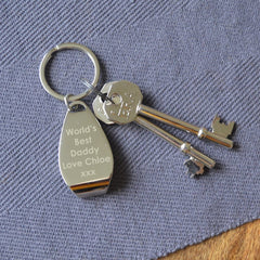 A personalised engraved bottle opener keyring on a table