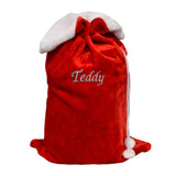 A personalised red and white fluffy Christmas sack with a name embroidered on the front in silver thread