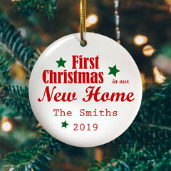 A personalised ceramic bauble with the message "First Christmas in our New Home, the Smiths 2018" printed on it