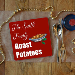 A personalised Christmas placemat with roast potatoes on, the placemat also has text saying "the Smith family roast potatoes"
