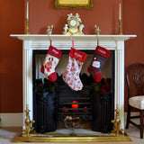 personalised stockings hanging over a fireplace