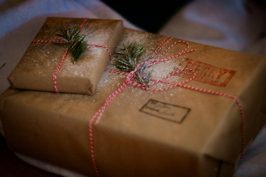 Christmas Eve Box wrapped in brown paper and tied with red and white string in a bow