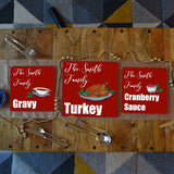 3 personalised Christmas placemats with turkey, gravy and cranberry sauce illustrations on them 