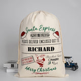 A personalised cream cotton Santa sack with red, green and black lettering and a vintage style design which is customised with a child's name.