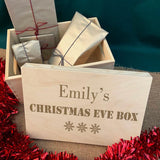 A custom Christmas eve box with an engraved design on the lid.