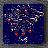 A dark blue personalised square coaster with a winter tree design, the coaster is personalised with the name "Emily"