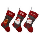 3 personalised Christmas stockings in dark grey and red felt. One features a reindeer, one a snowman and one Santa. Each stocking is embroidered with a name in white lettering. 