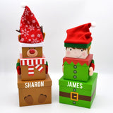 Personalised Christmas gift boxes with reindeer and elf designs.