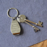 A personalised engraved bottle opener keyring on a table 