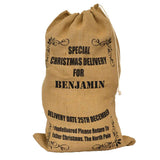 A personalised hessian Santa sack with black lettering in a postal service style design.