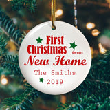 A personalised ceramic bauble with the message "First Christmas in our New Home, the Smiths 2018" printed on it