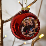 A personalised red photo bauble with a picture of a man and woman printed on it