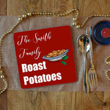 A personalised Christmas placemat with roast potatoes on, the placemat also has text saying "the Smith family roast potatoes" 
