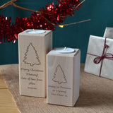 Two personalised Christmas candle holders with engraved messages and Christmas tree icons on the front.