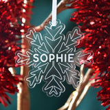 A personalised snowflake shaped Christmas decoration with the name "Sophie" engraved on the front