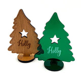 Wood and acrylic christmas decorations shaped like trees with name engraved. 
