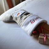 A personalised Christmas stocking on the end of a child's bed 